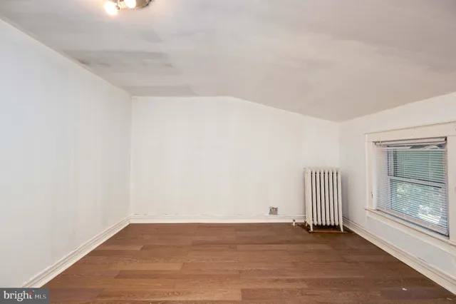 a view of a room with wooden floor and window