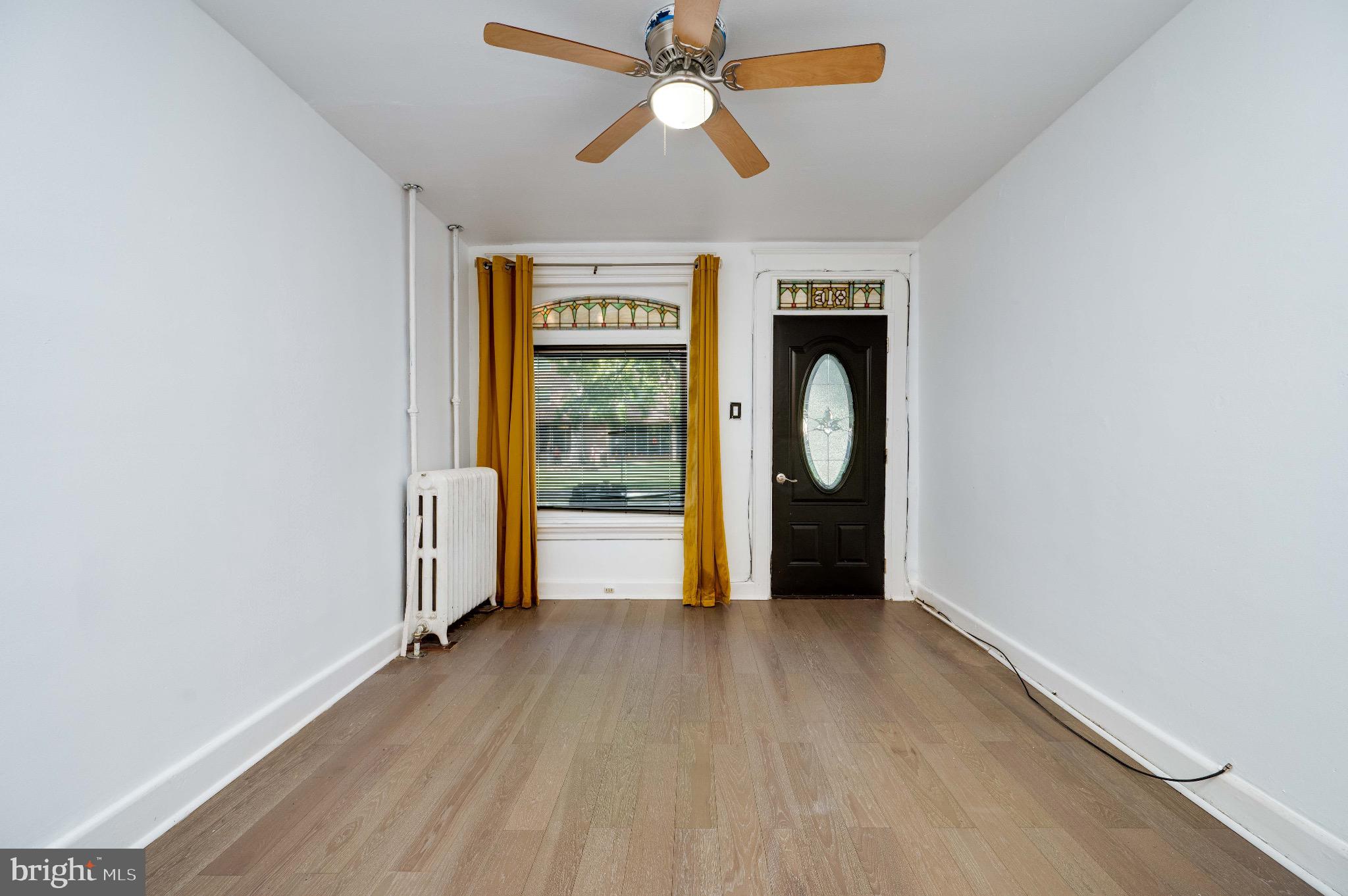 816 Franklin Street Reading, PA 19602 - Photo 2 of 20 wooden floor in an empty room with a window