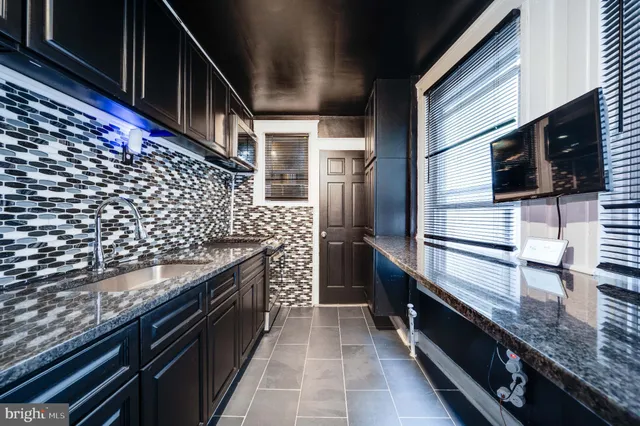 a kitchen with granite countertop stainless steel appliances and wooden cabinets