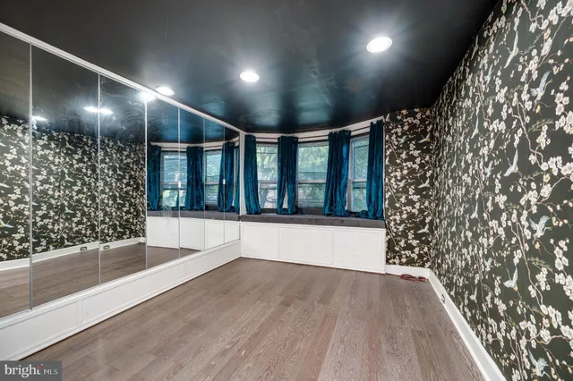 a view of gallery with wooden floor