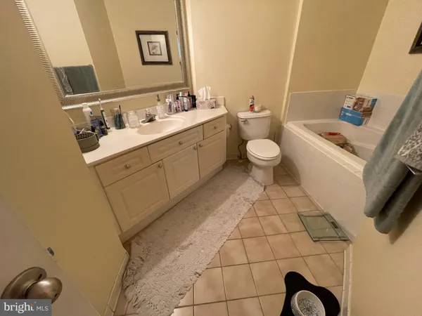 a bathroom with a sink toilet and a mirror