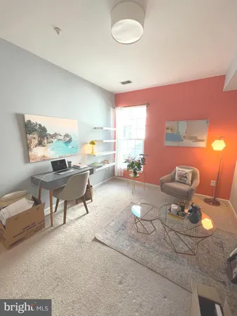 a living room with furniture a window and a lamp