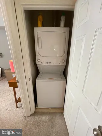 a utility room with wooden floor washer and dryer