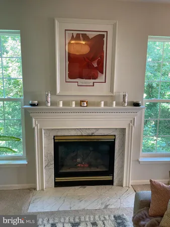 a living room with a fireplace and a window