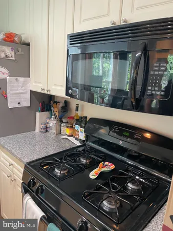 a stove top oven sitting inside of a kitchen