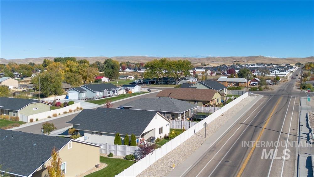 2160 East Ridgeview Avenue Payette, ID 83661 - Photo 30 of 32 Residential street with multiple single-story homes featuring shingle roofs and fenced yards