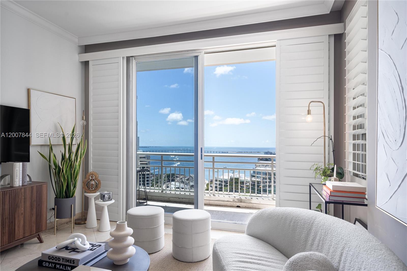 888 Brickell Key Drive, Unit 2602 Miami, FL 33131 - Photo 1 of 29 a living room with furniture and a potted plant