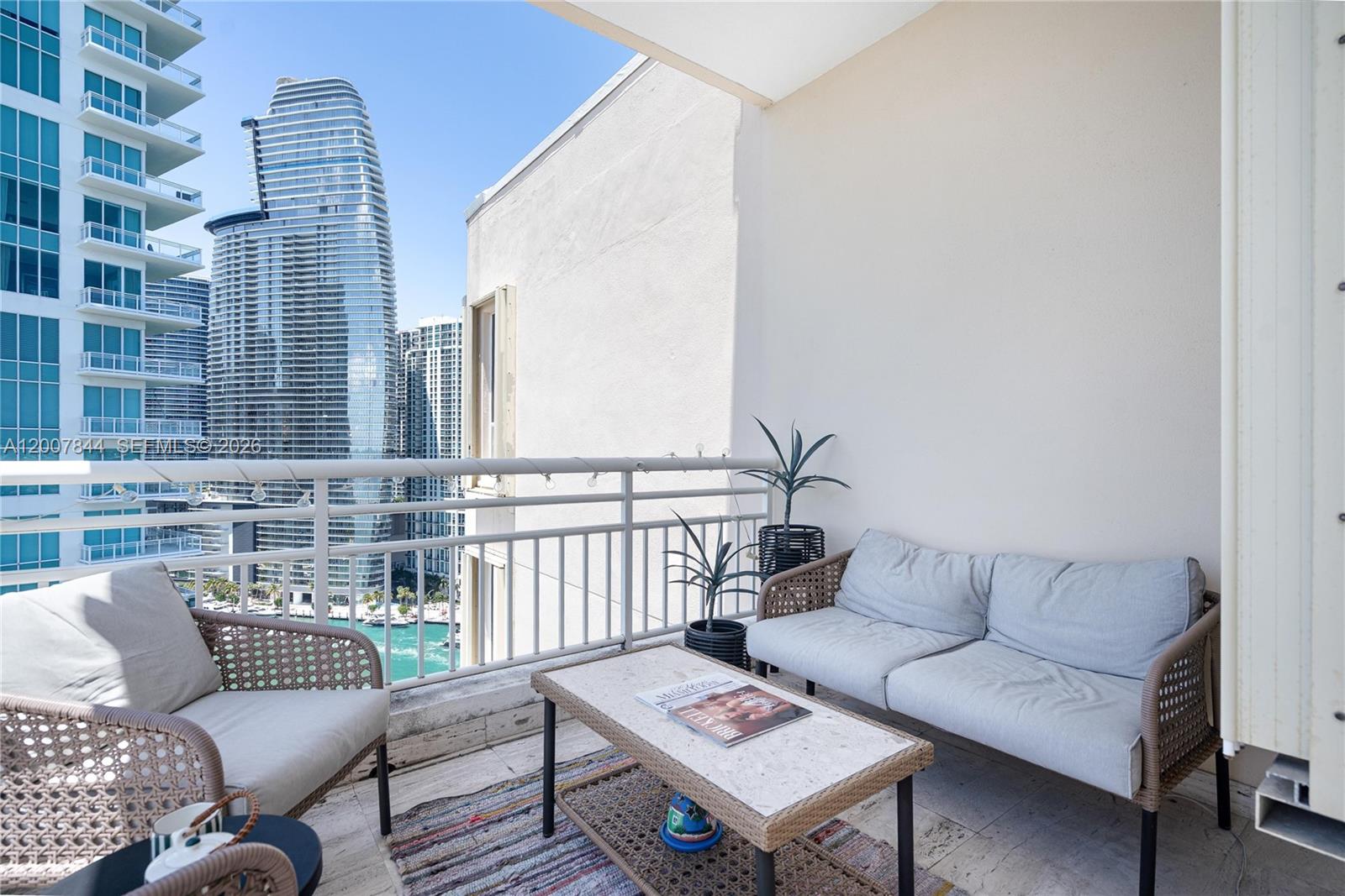 888 Brickell Key Drive, Unit 2602 Miami, FL 33131 - Photo 13 of 29 a living room with furniture and a rug