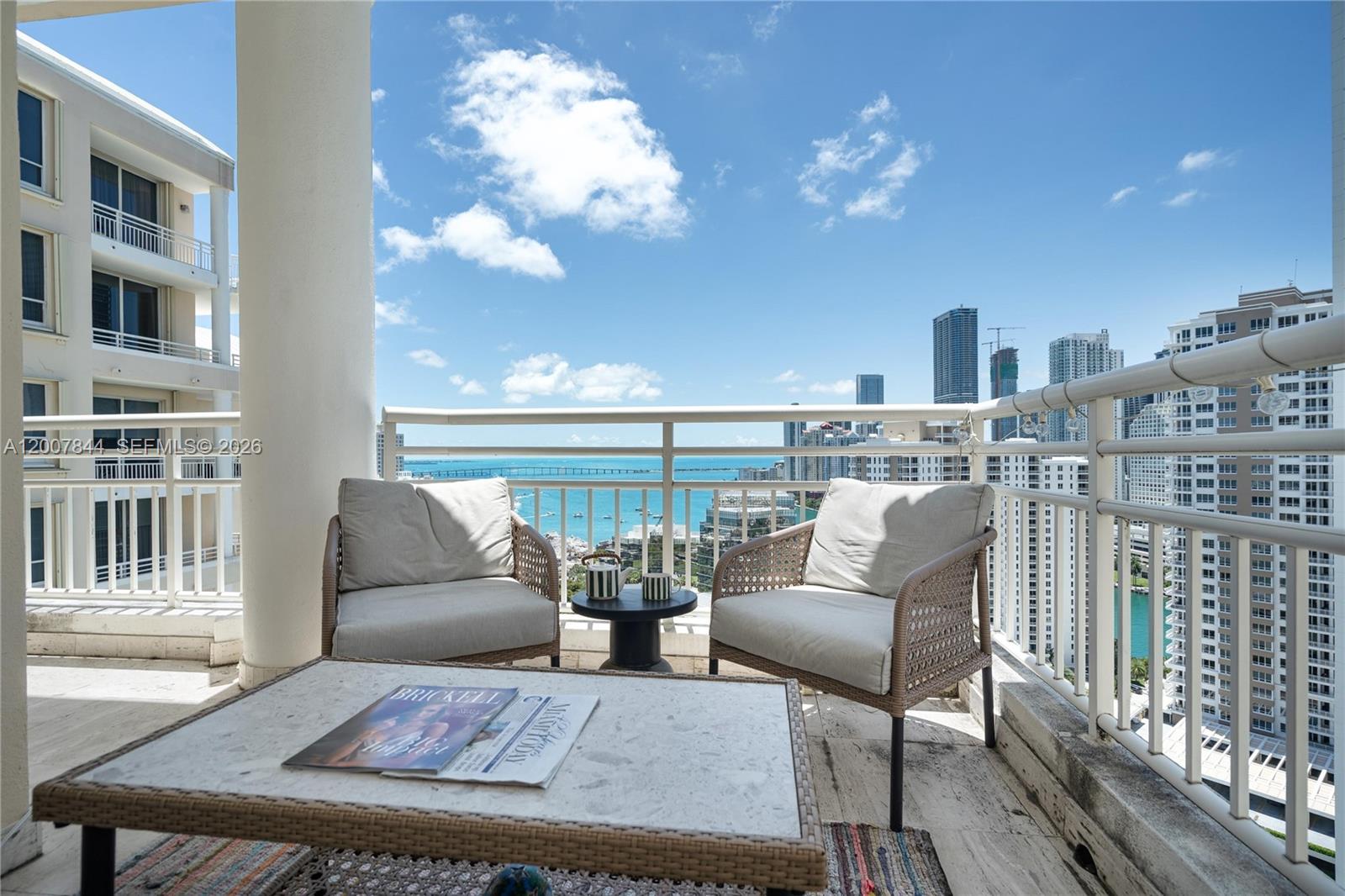 888 Brickell Key Drive, Unit 2602 Miami, FL 33131 - Photo 14 of 29 a balcony with furniture and wooden floor