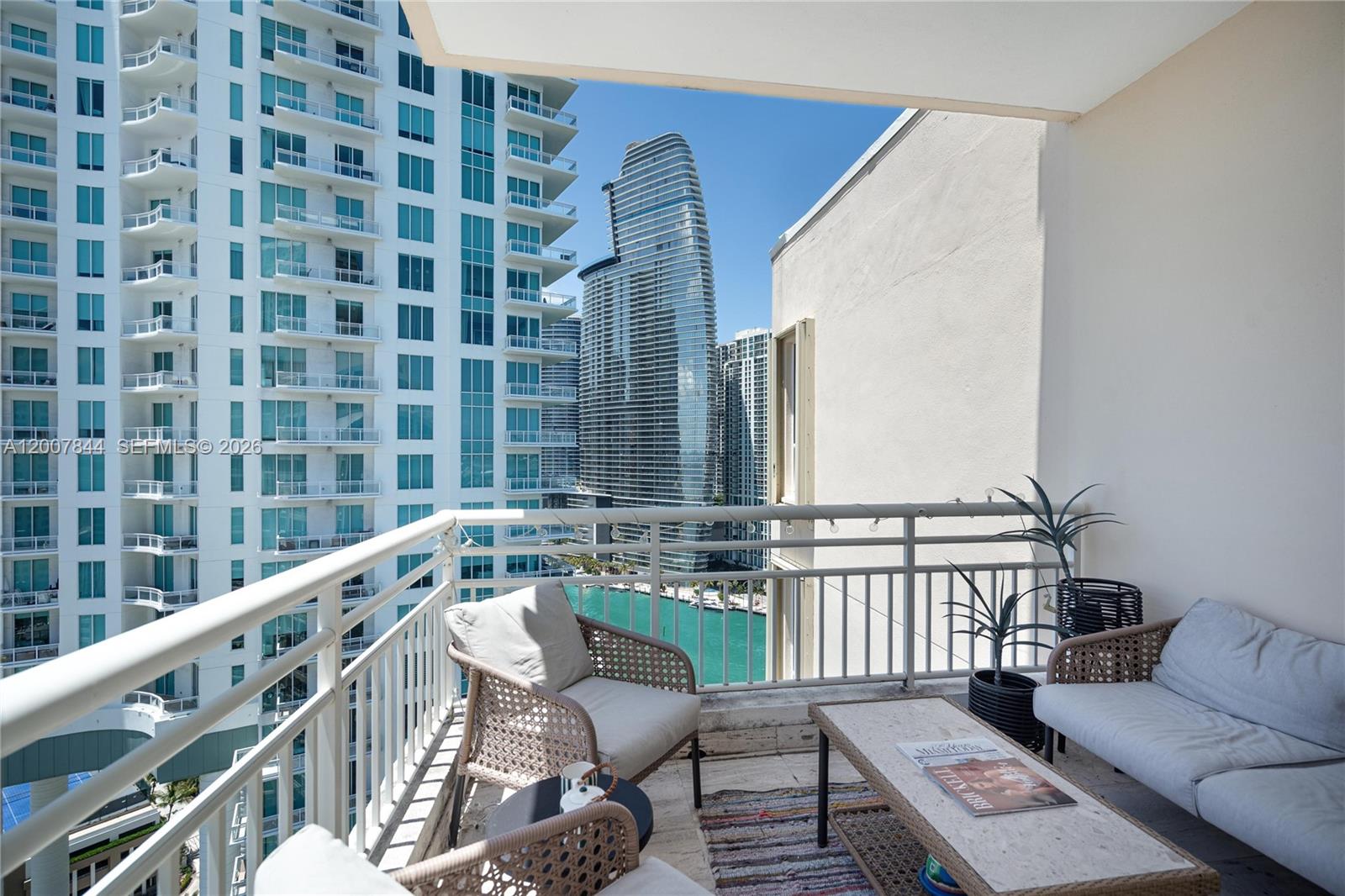888 Brickell Key Drive, Unit 2602 Miami, FL 33131 - Photo 15 of 29 a balcony with wooden floor and furniture