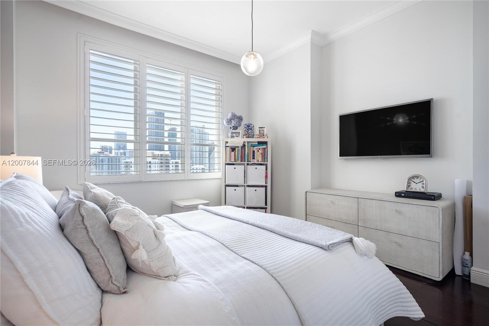 888 Brickell Key Drive, Unit 2602 Miami, FL 33131 - Photo 20 of 29 a bedroom with a bed a flat screen tv and a window