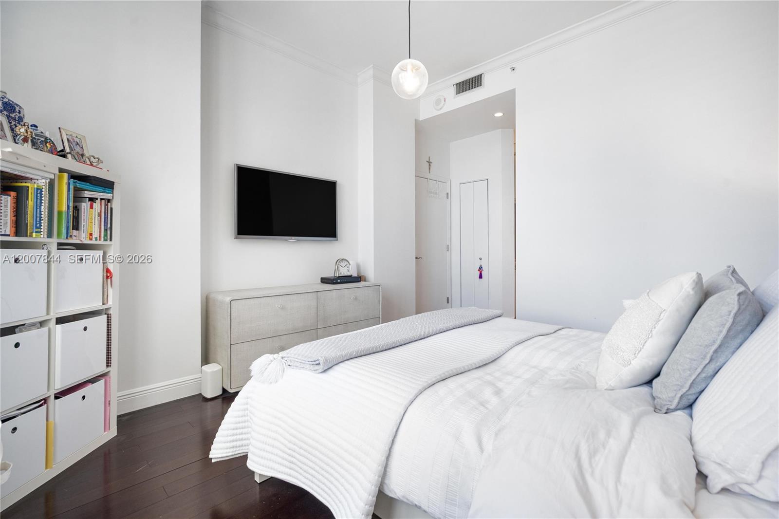 888 Brickell Key Drive, Unit 2602 Miami, FL 33131 - Photo 21 of 29 a bedroom with a bed and a flat screen tv