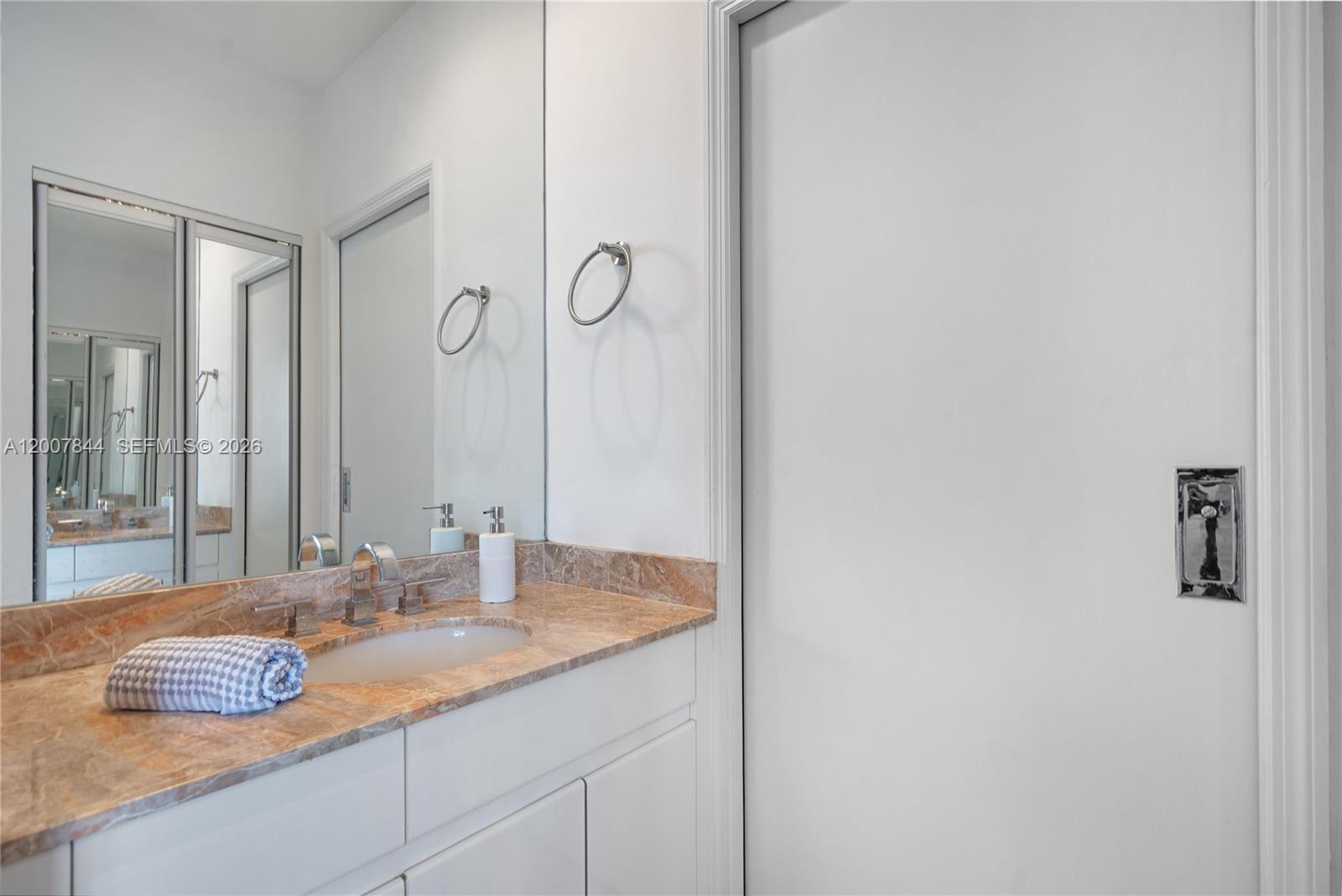 888 Brickell Key Drive, Unit 2602 Miami, FL 33131 - Photo 23 of 29 a bathroom with a granite countertop sink and a mirror