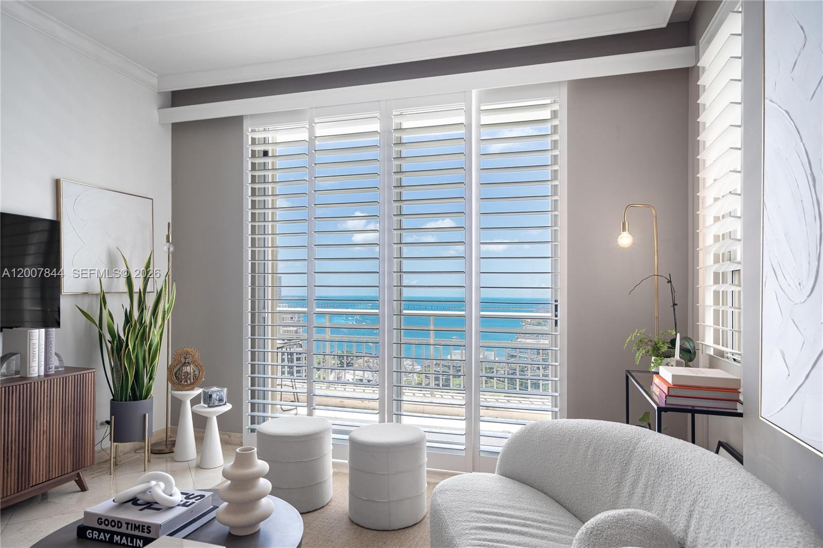 888 Brickell Key Drive, Unit 2602 Miami, FL 33131 - Photo 5 of 29 a living room with furniture and a potted plant