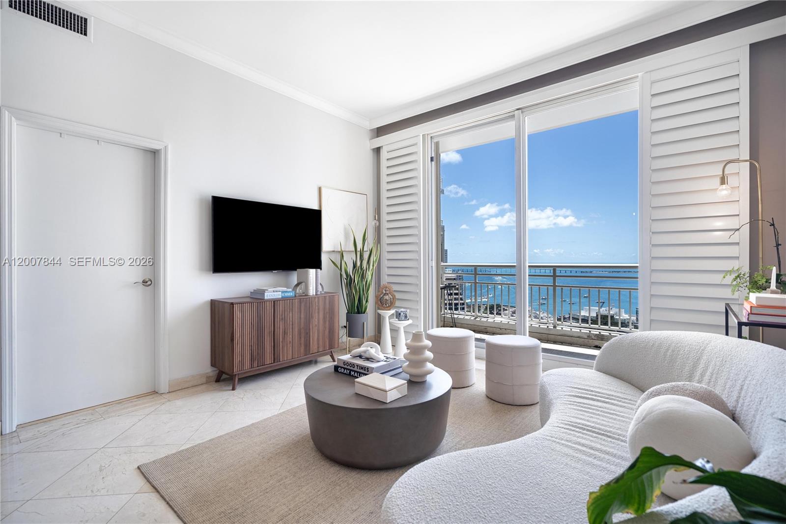 888 Brickell Key Drive, Unit 2602 Miami, FL 33131 - Photo 7 of 29 a living room with furniture and a flat screen tv