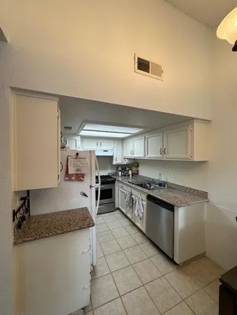 a kitchen with stainless steel appliances granite countertop a stove and a sink