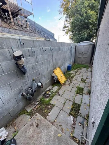 a view of a backyard with sitting area