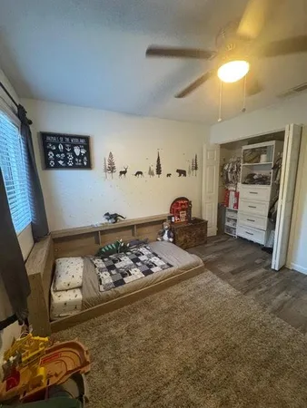 a bedroom with furniture and a window