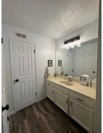 a bathroom with a double vanity sink and mirror