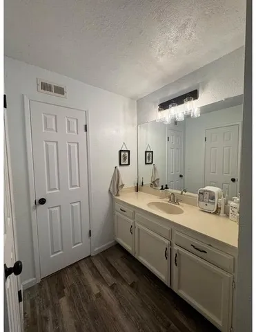a bathroom with a double vanity sink and mirror