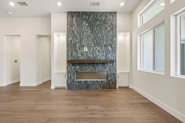 a large kitchen with stainless steel appliances lots of white cabinets and wooden floors