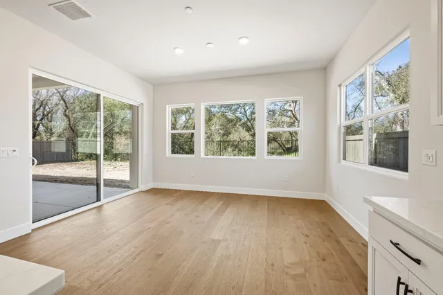 a view of a kitchen with a sink and dishwasher with wooden floor