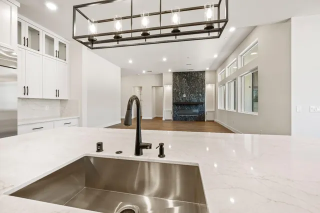 a kitchen with white cabinets and white appliances