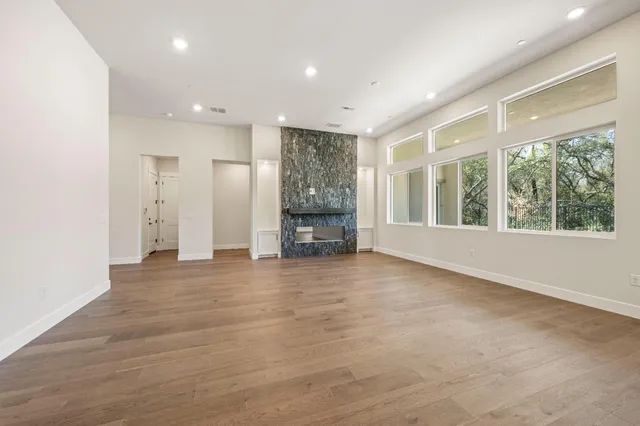 a kitchen with stainless steel appliances a stove top oven and a wooden floor