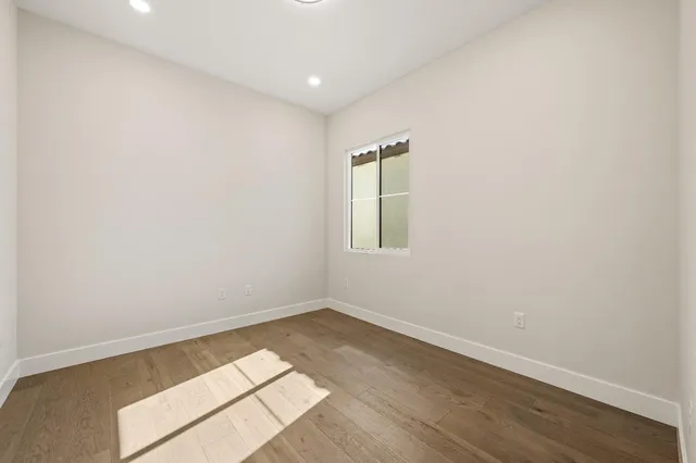a kitchen with granite countertop white cabinets and sink