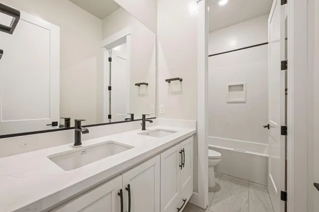 an empty room with windows and cabinet