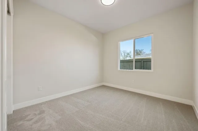 a view of backyard with window and wooden floor