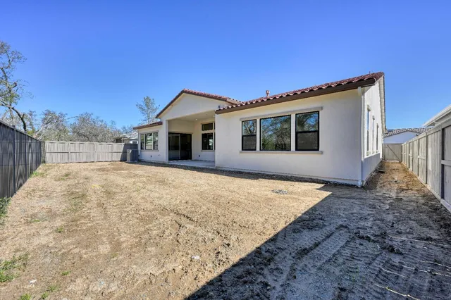 a front view of house with wooden fence
