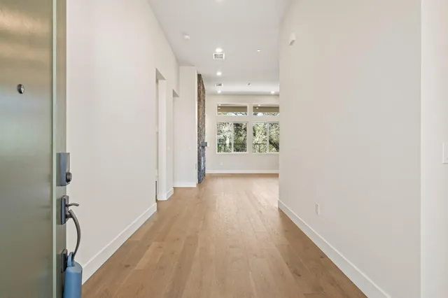 a view of an empty room and wooden floor