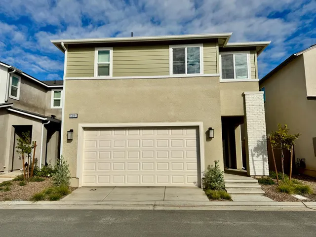 a front view of a house with garage