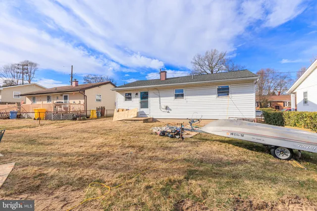 a view of house with backyard and seating area