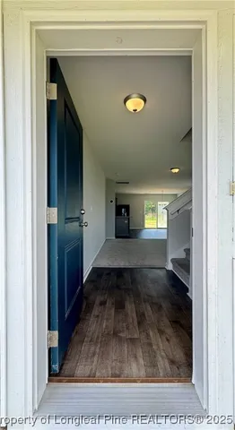 a view of a hallway view with wooden floor and staircase