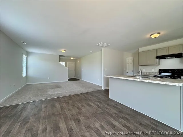 a view of kitchen with sink and microwave
