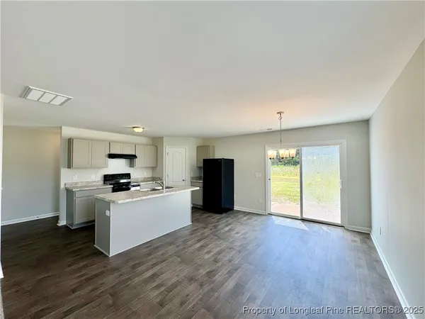 a kitchen with stainless steel appliances a refrigerator sink and stove top oven