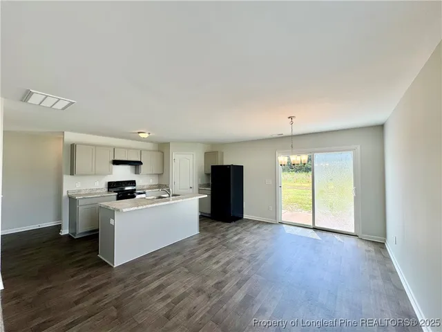a kitchen with stainless steel appliances a refrigerator sink and stove top oven