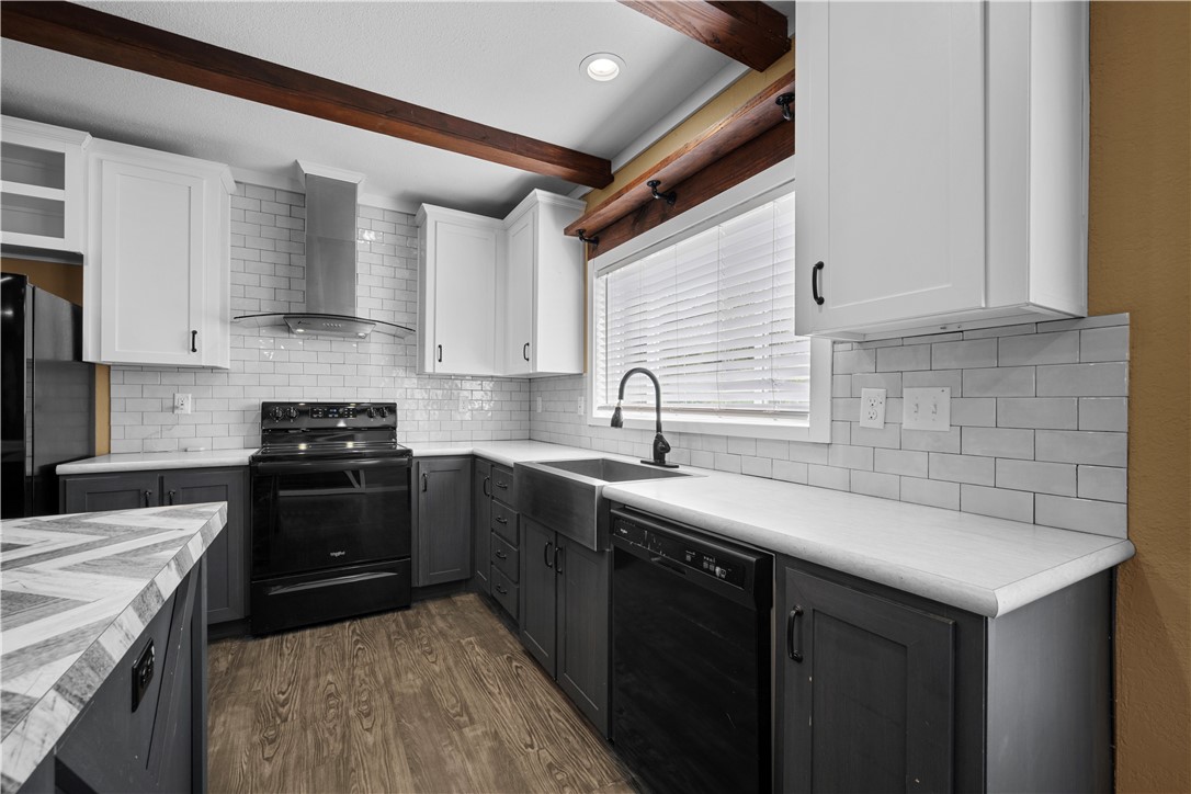 1511 Monkey Road Rockport, TX 78382 - Photo 13 of 40 a kitchen with a sink stove and cabinets