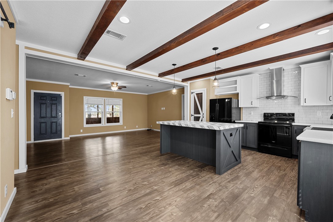 1511 Monkey Road Rockport, TX 78382 - Photo 15 of 40 a large kitchen with stainless steel appliances granite countertop a large counter top a stove and a refrigerator