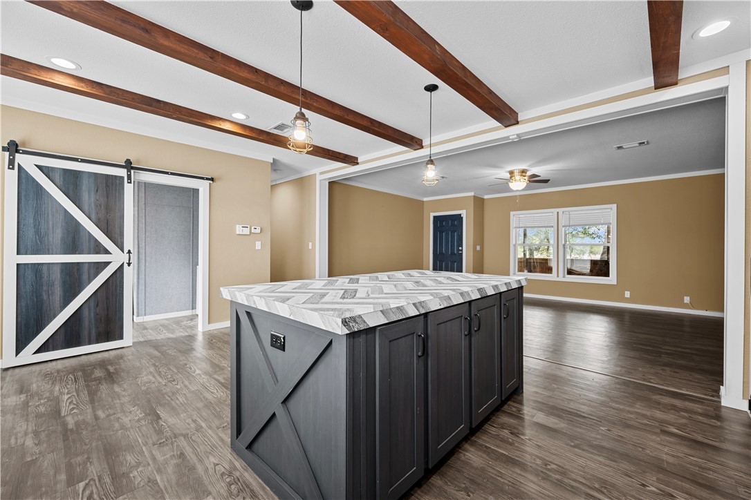 1511 Monkey Road Rockport, TX 78382 - Photo 16 of 40 a kitchen with a stove and a wooden floor