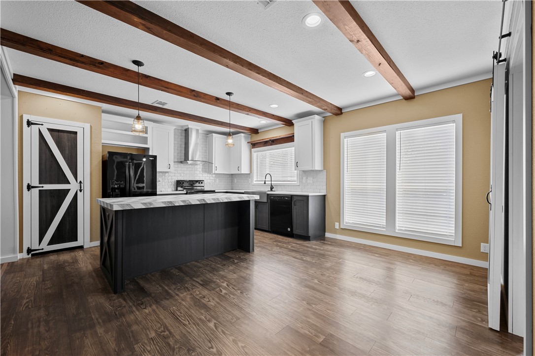 1511 Monkey Road Rockport, TX 78382 - Photo 17 of 40 a large kitchen with stainless steel appliances granite countertop a stove a sink and a refrigerator