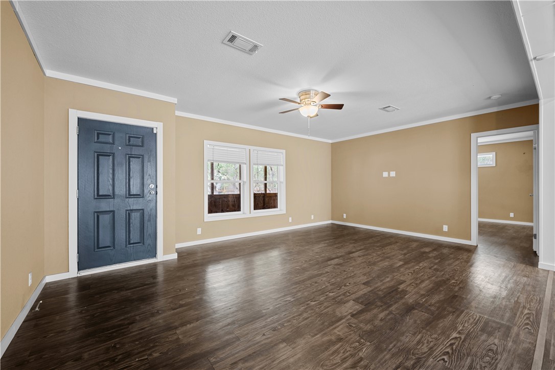 1511 Monkey Road Rockport, TX 78382 - Photo 18 of 40 a view of an empty room with a window and wooden floor