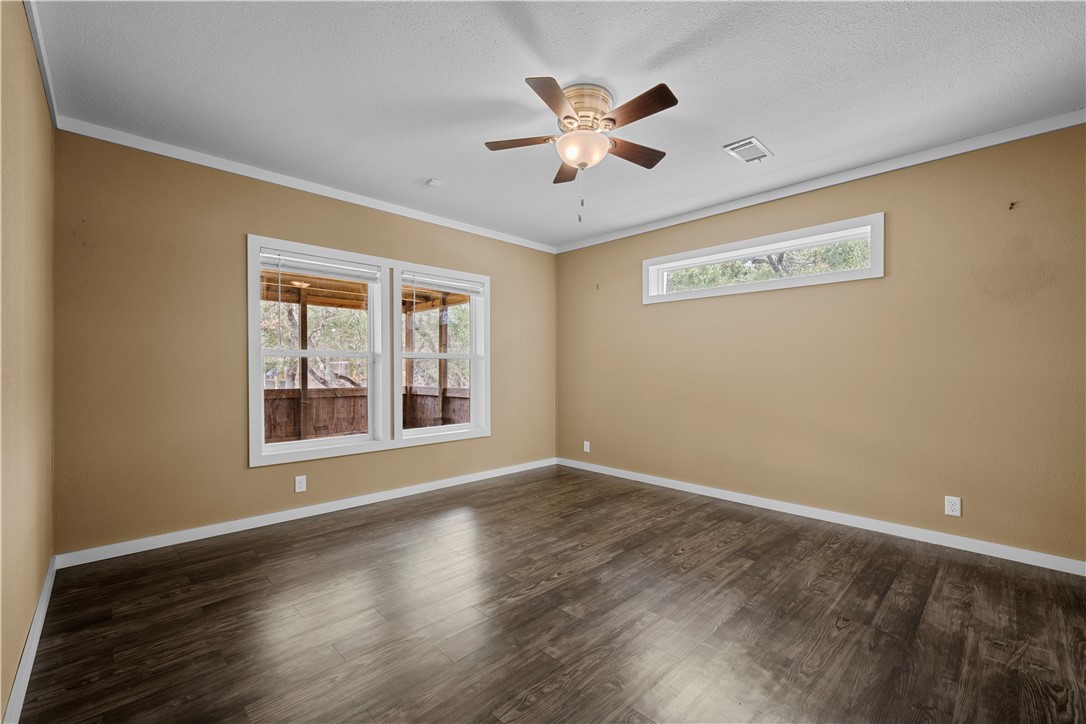 1511 Monkey Road Rockport, TX 78382 - Photo 20 of 40 a view of an empty room with wooden floor and a window