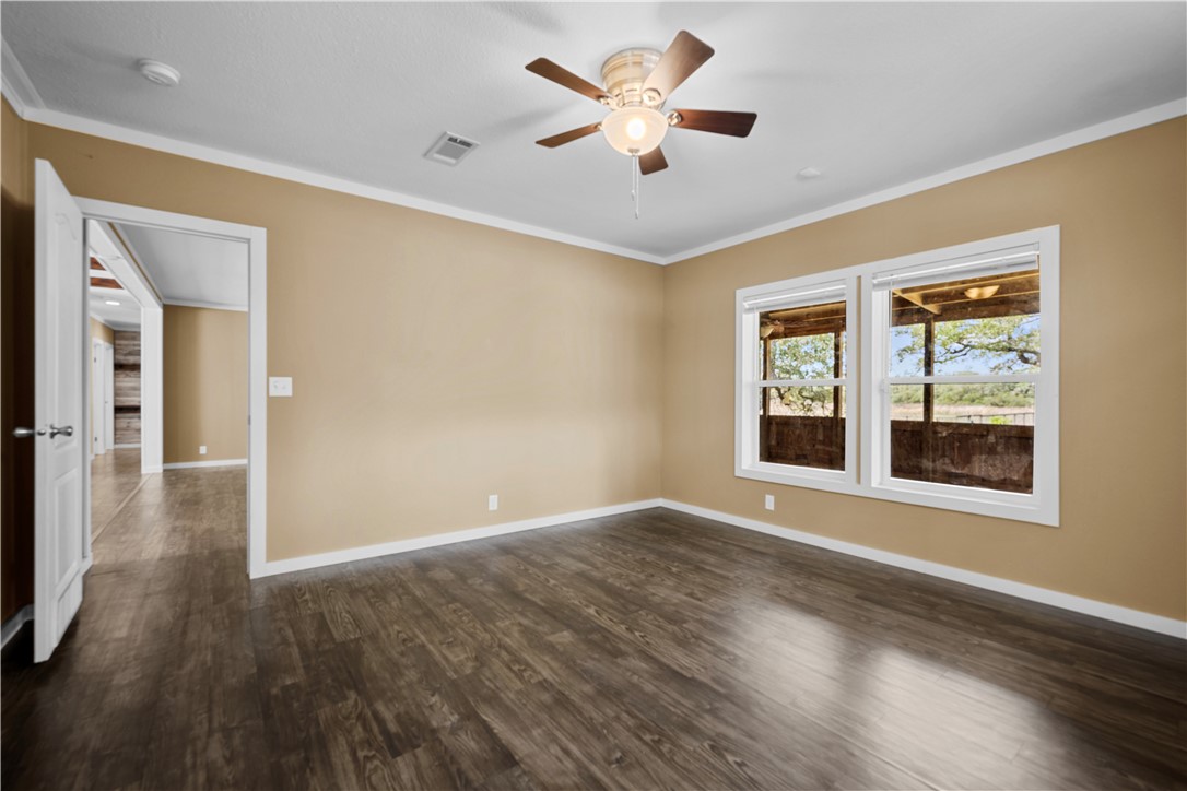 1511 Monkey Road Rockport, TX 78382 - Photo 21 of 40 a view of an empty room with a window and wooden floor