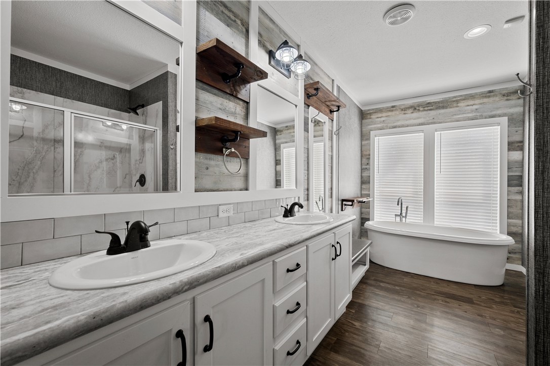 1511 Monkey Road Rockport, TX 78382 - Photo 24 of 40 a bathroom with a double vanity sink and a mirror