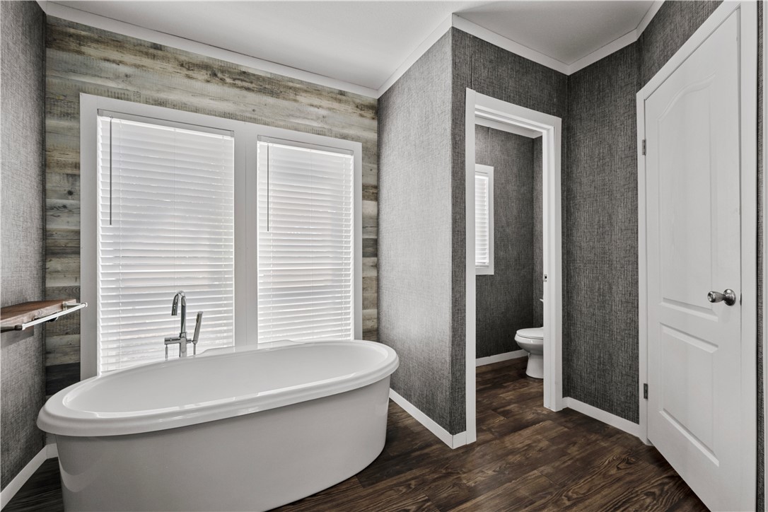 1511 Monkey Road Rockport, TX 78382 - Photo 25 of 40 a white toilet sitting next to a bathroom sink