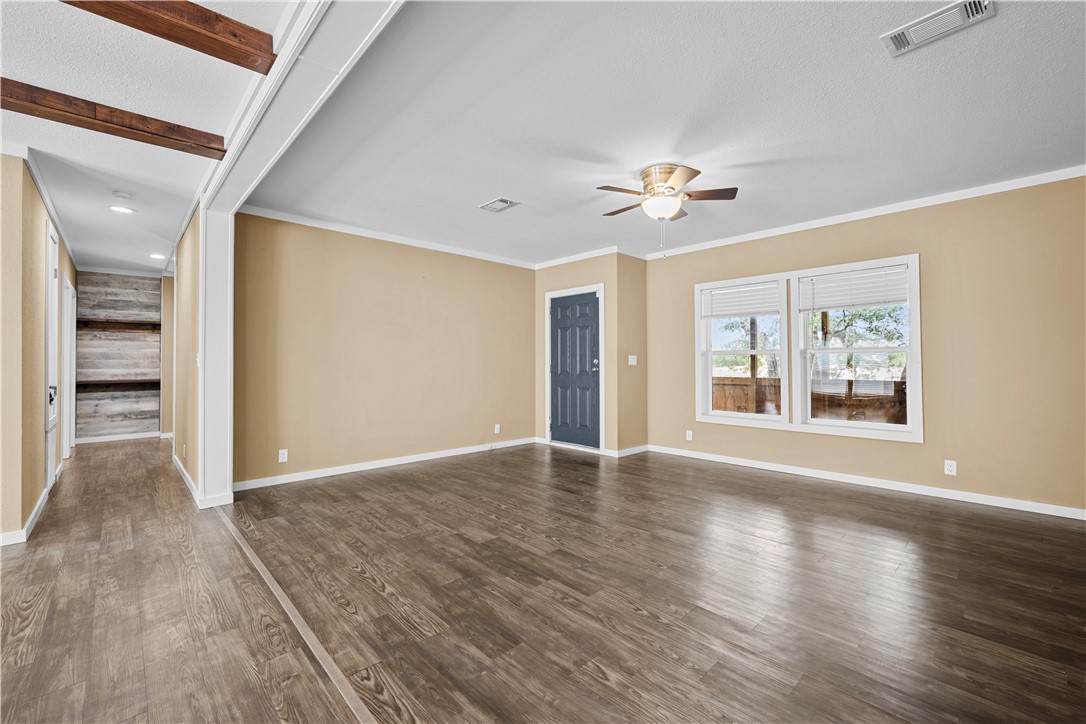 1511 Monkey Road Rockport, TX 78382 - Photo 27 of 40 a view of an empty room with a window and wooden floor