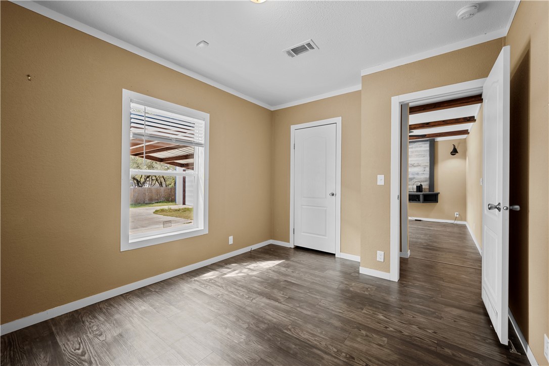 1511 Monkey Road Rockport, TX 78382 - Photo 30 of 40 a view of an empty room with wooden floor and a window